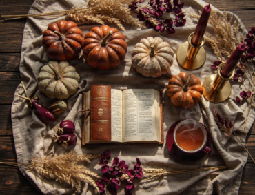 Autumn harvest table setting with Bible and gold candlesticks